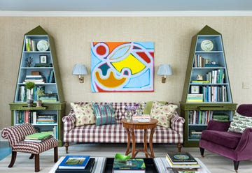 a living room with a couch and bookshelves