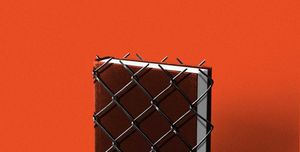 a black hardcover book wrapped in fencing against a red backdrop