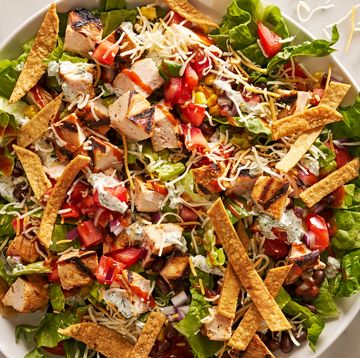 bbq chicken salad with barbecue sauce, chicken, toppings, and a creamy dressing