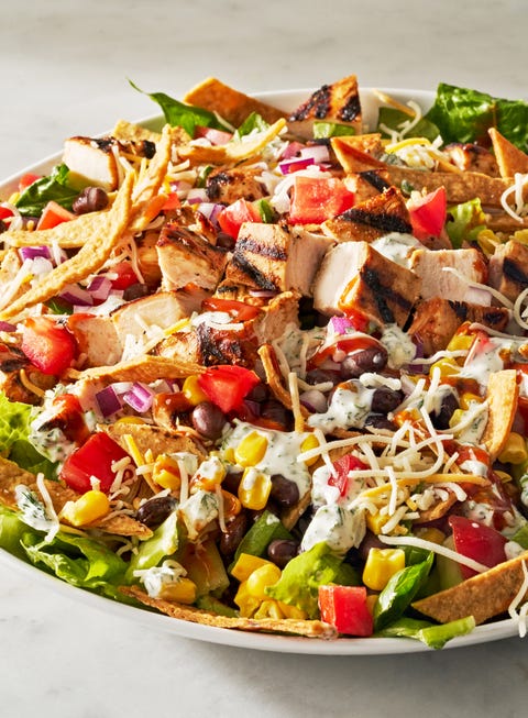 bbq chicken salad with barbecue sauce, chicken, toppings, and a creamy dressing