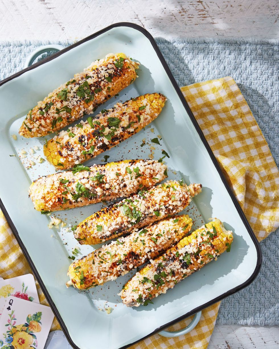 mexican street corn arranged on a light blue serving tray