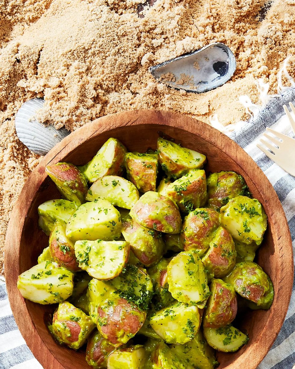 chive potato salad in a wooden bowl on a beach blanket
