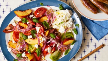 a summer salad with tomato, peaches, onion, and cheese