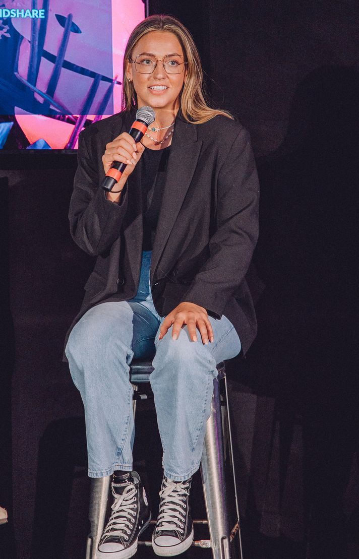 a person sitting on a chair holding a microphone