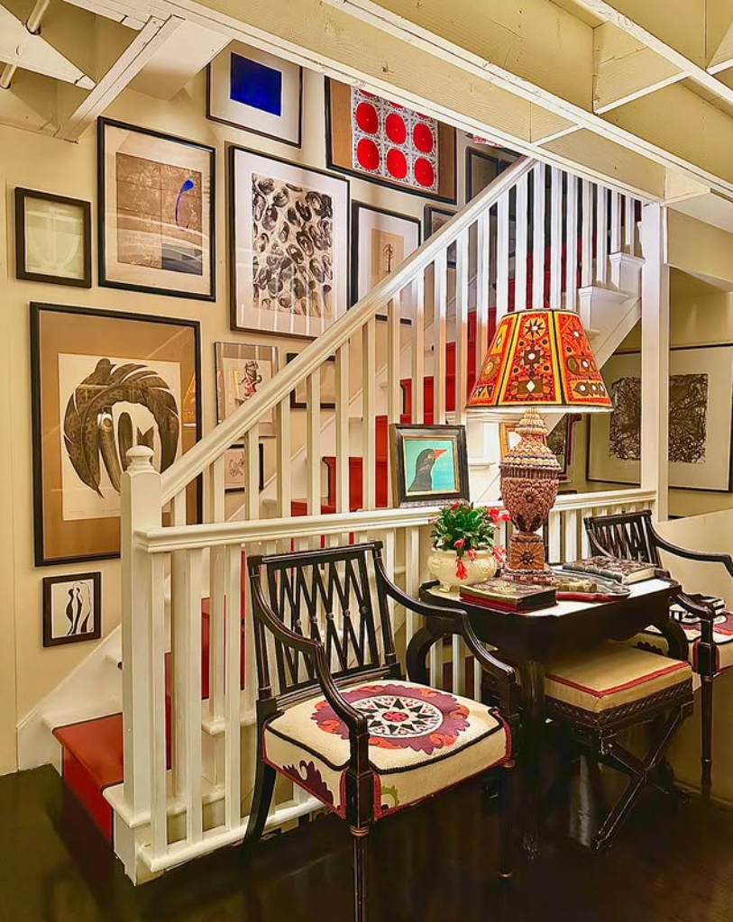 Staircase area featuring a gallery wall and seating.