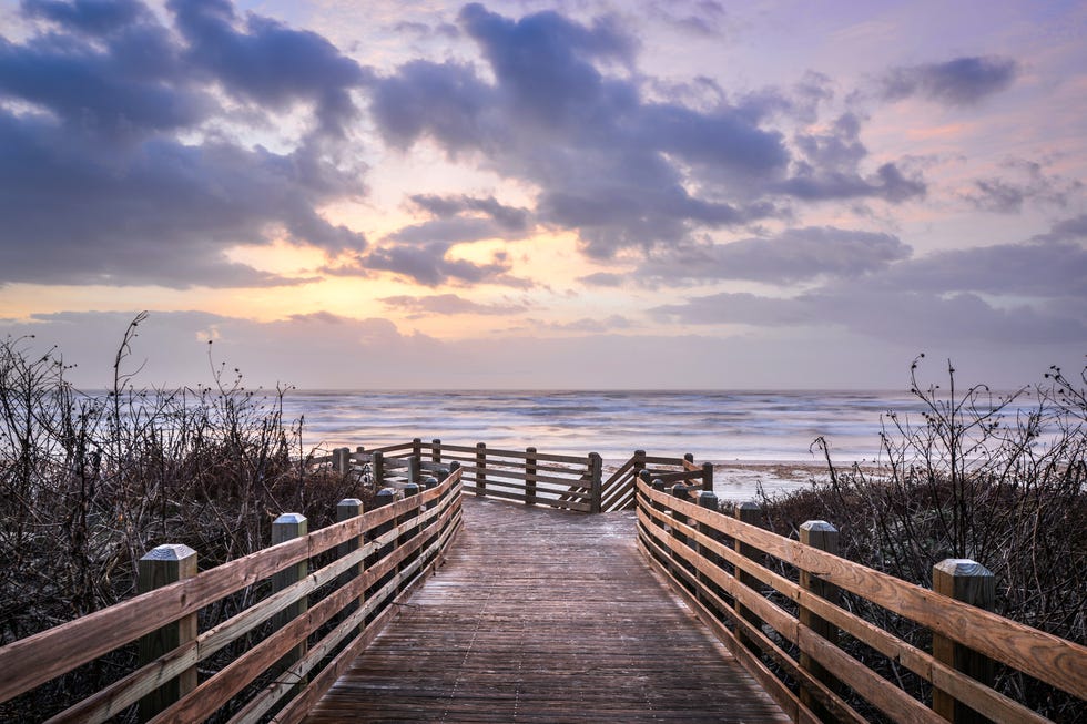 beach boardwalk at sunrise in port aransas, texas, usa