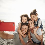 family taking self portrait on beach