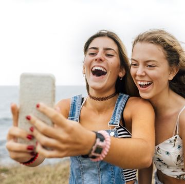 friends taking selfie on the beach