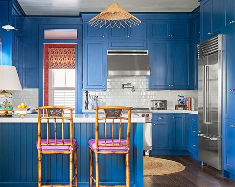 blue kitchen with purple and rattan bar stools