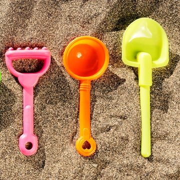 beach toys lined up in sand