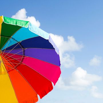 rainbow beach umbrellas against blue sky