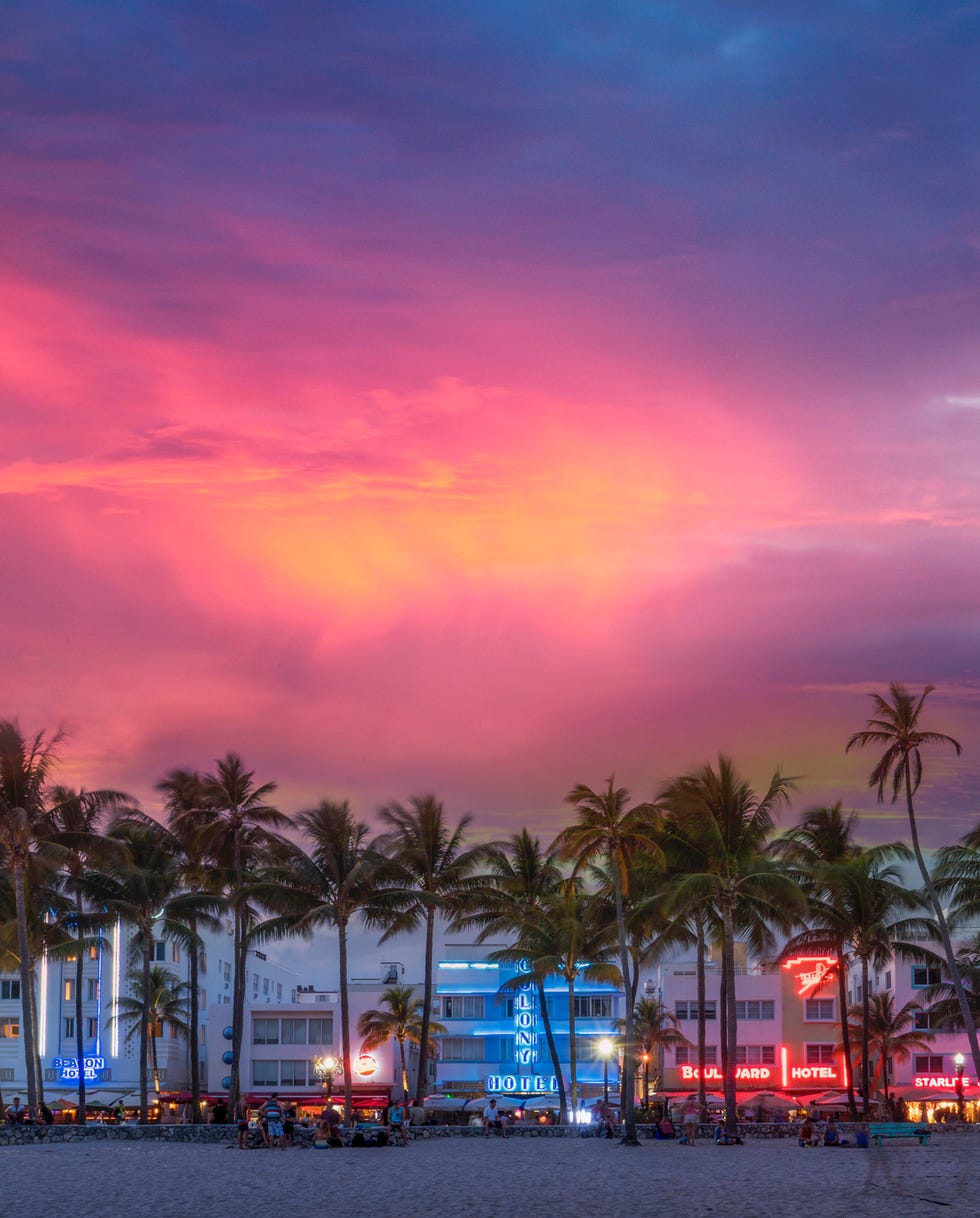 beachfront buildings under sunset sky