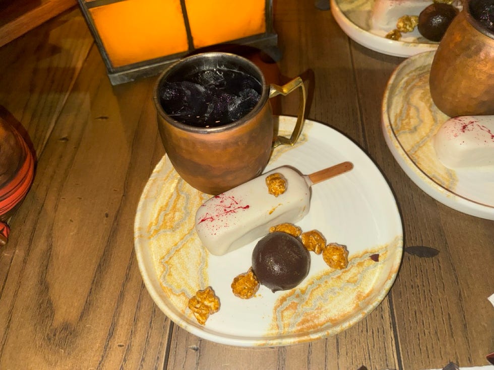a plate with a mug and desserts at the beak and barrel