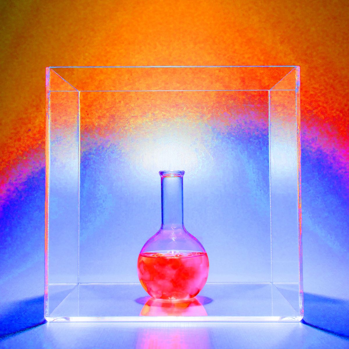 beaker with colorful chemicals in clear box box
