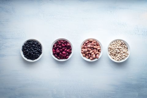 beans of different colors, in bowls each group, on a white background