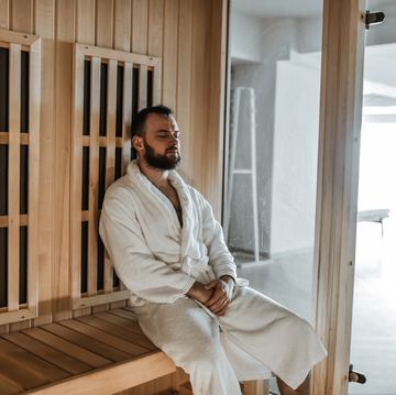 bearded male using sauna for it's therapeutic properties