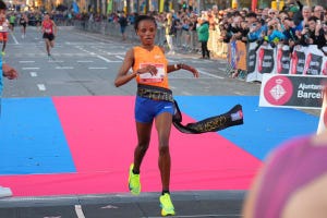 runner crossing the finish line at a marathon event