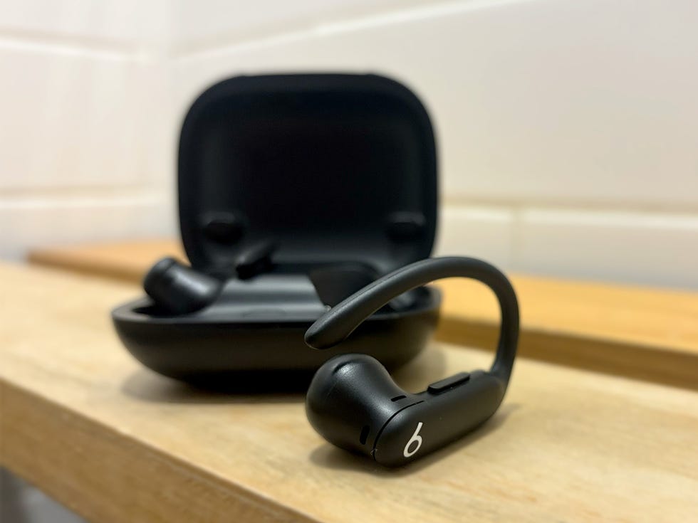 wireless earbuds next to their charging case