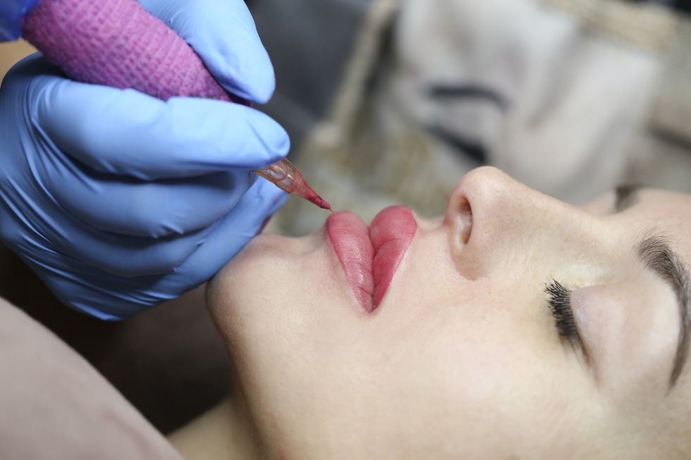 beautician applying permanent make up