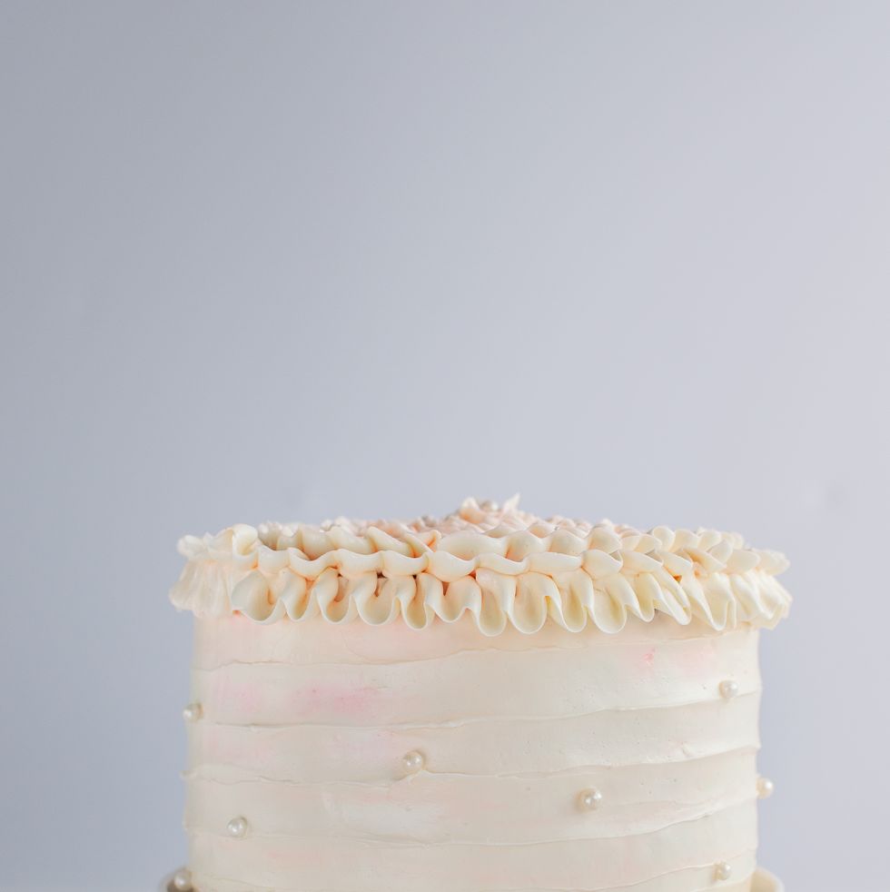 beautiful birthday cake decorate with edible pearls on white neutral background copy space