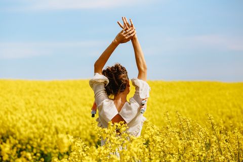 beautiful blonde girl posing in yellow field