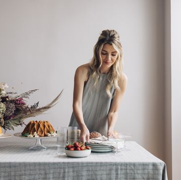 beautiful blonde woman setting the table for a birthday party