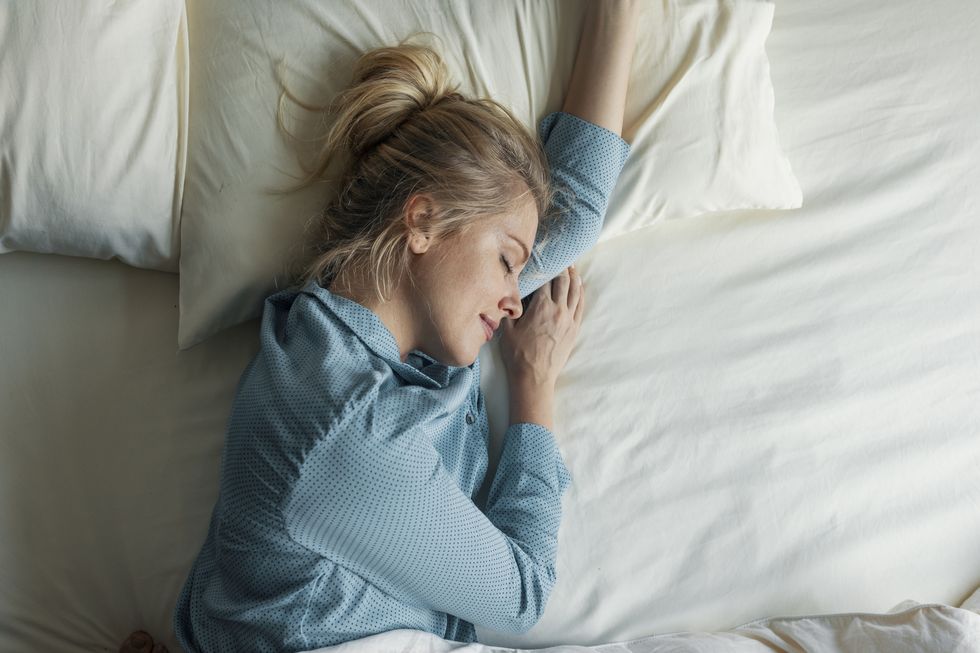 beautiful blonde woman sleeping peacefully in her bed