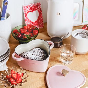 pink heart shaped dutch oven with chocolate cake inside