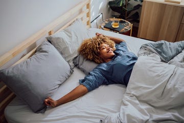 beautiful cheerful woman having a lazy weekend in bed