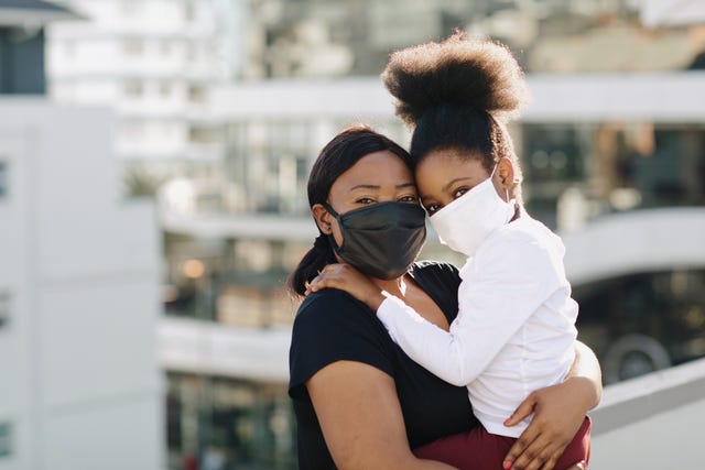 during the covid 19 pandemic a mother and daughter wear face masks