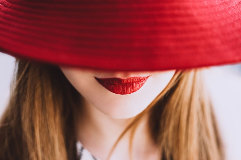 beautiful fair haired woman with lips painted red lipstick