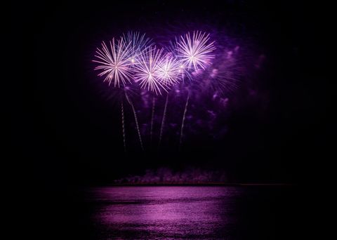 new years colors purple fireworks over water