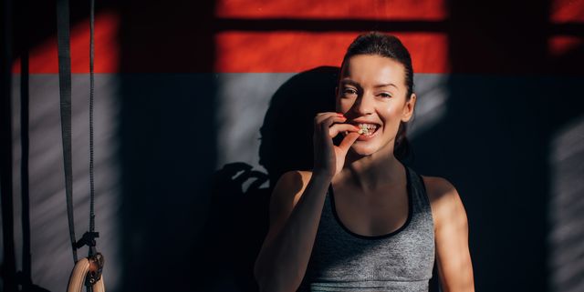 https://hips.hearstapps.com/hmg-prod/images/beautiful-fit-woman-eating-peanuts-in-gym-royalty-free-image-1748025428.pjpeg?crop=1.00xw:0.752xh;0,0.0481xh&resize=640:*