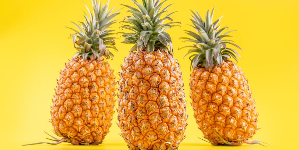 beautiful fresh pineapple isolated on bright yellow background,summer seasonal fruit design idea pa