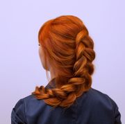 girl with long red hair, braided with a french braid
