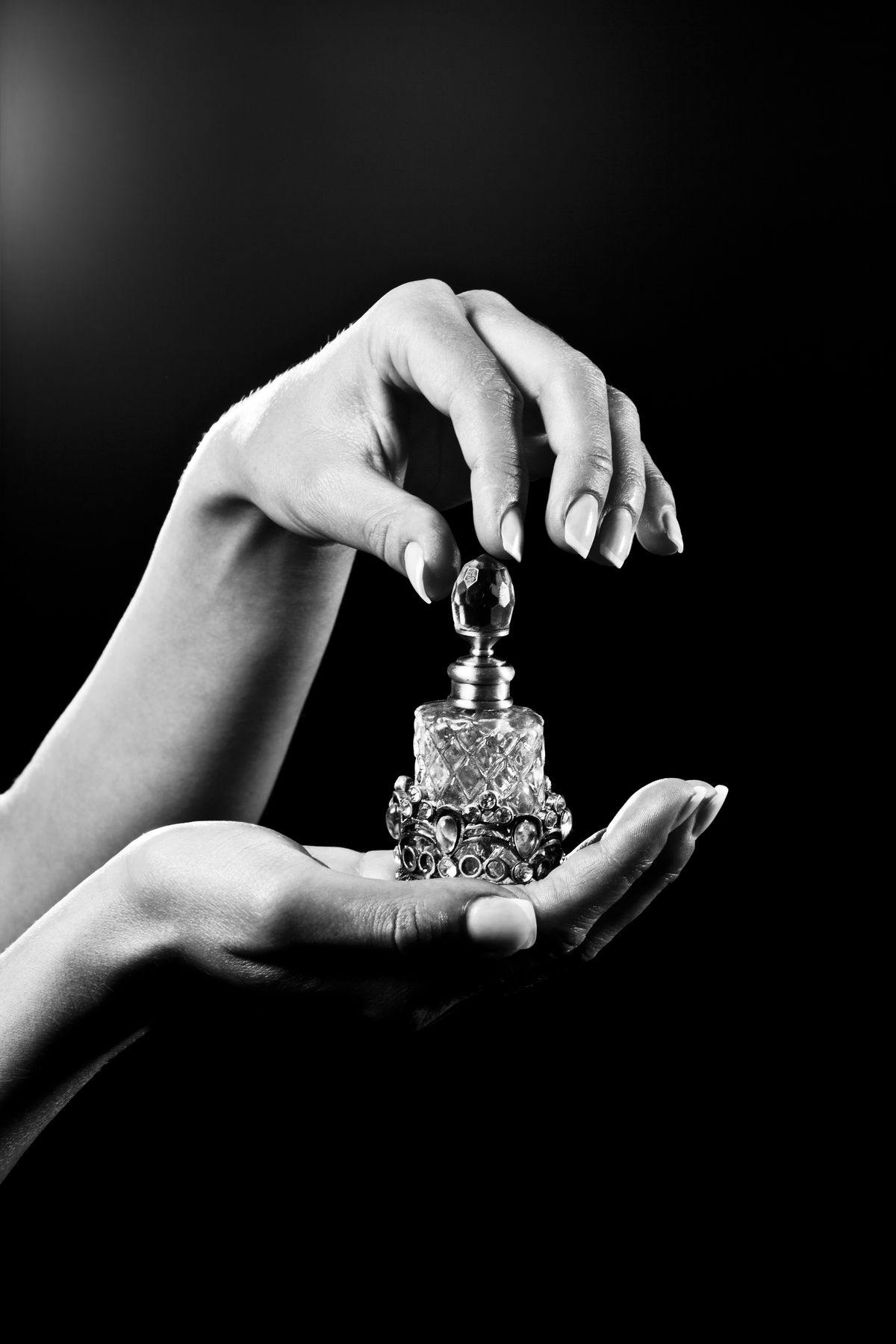 beautiful hands and luxury perfume bottle