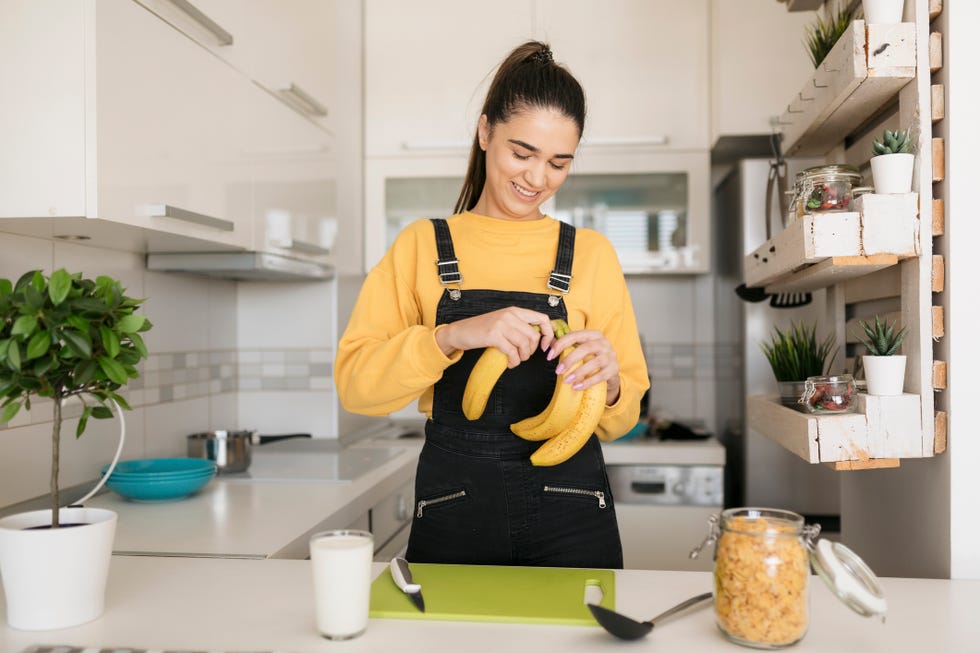 beautiful happy caucasian woman preparing herself a healthy breakfast