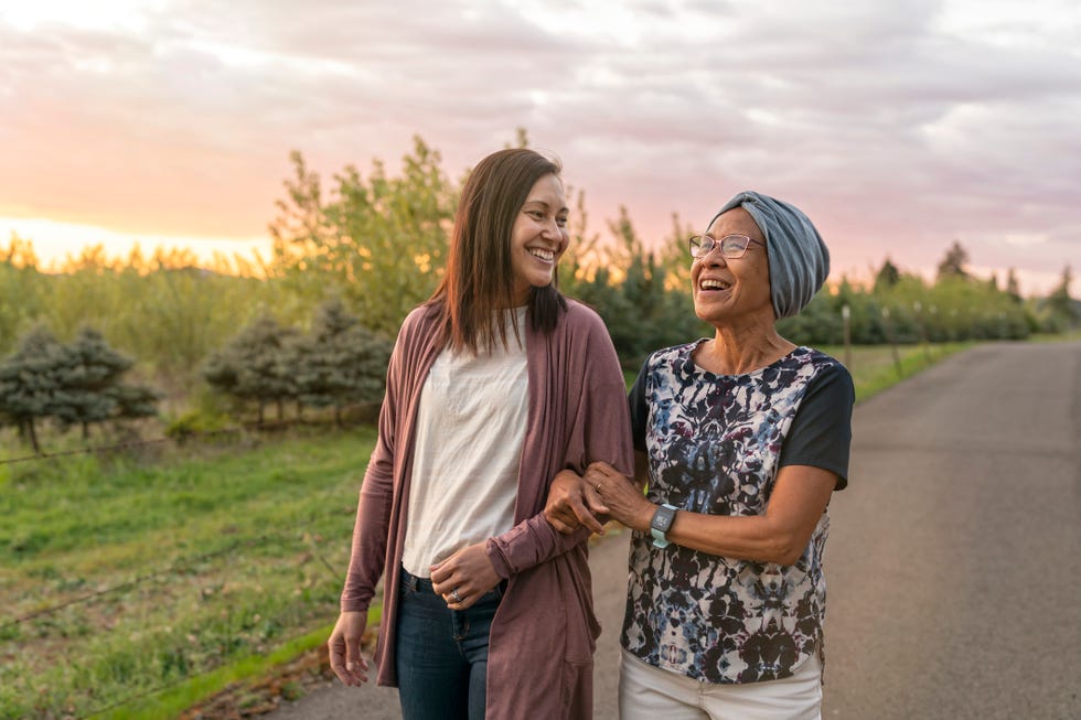 beautiful mixed race mother and daughter relaxing outdoors together