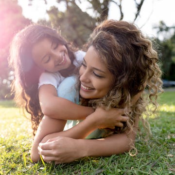 Beautiful portrait of a mother playing with her daughter outdoors beautiful portrait of a mother playing with her daughter outdoors