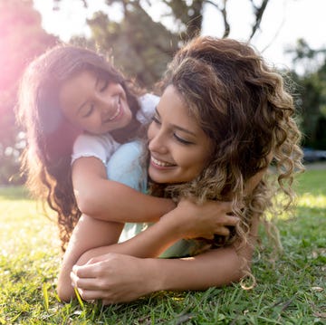 beautiful portrait of a mother playing with her daughter outdoors