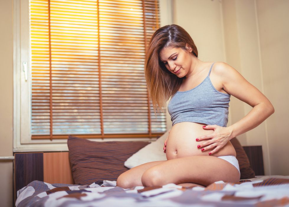 beautiful pregnant woman and prenatal care at home