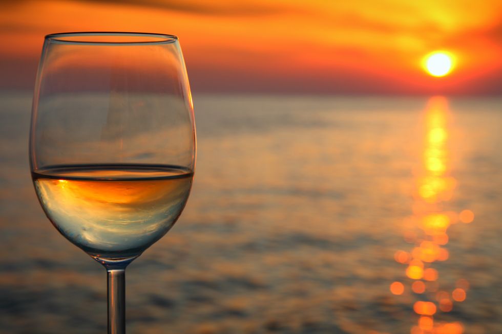 beautiful red sunset and glass of wine