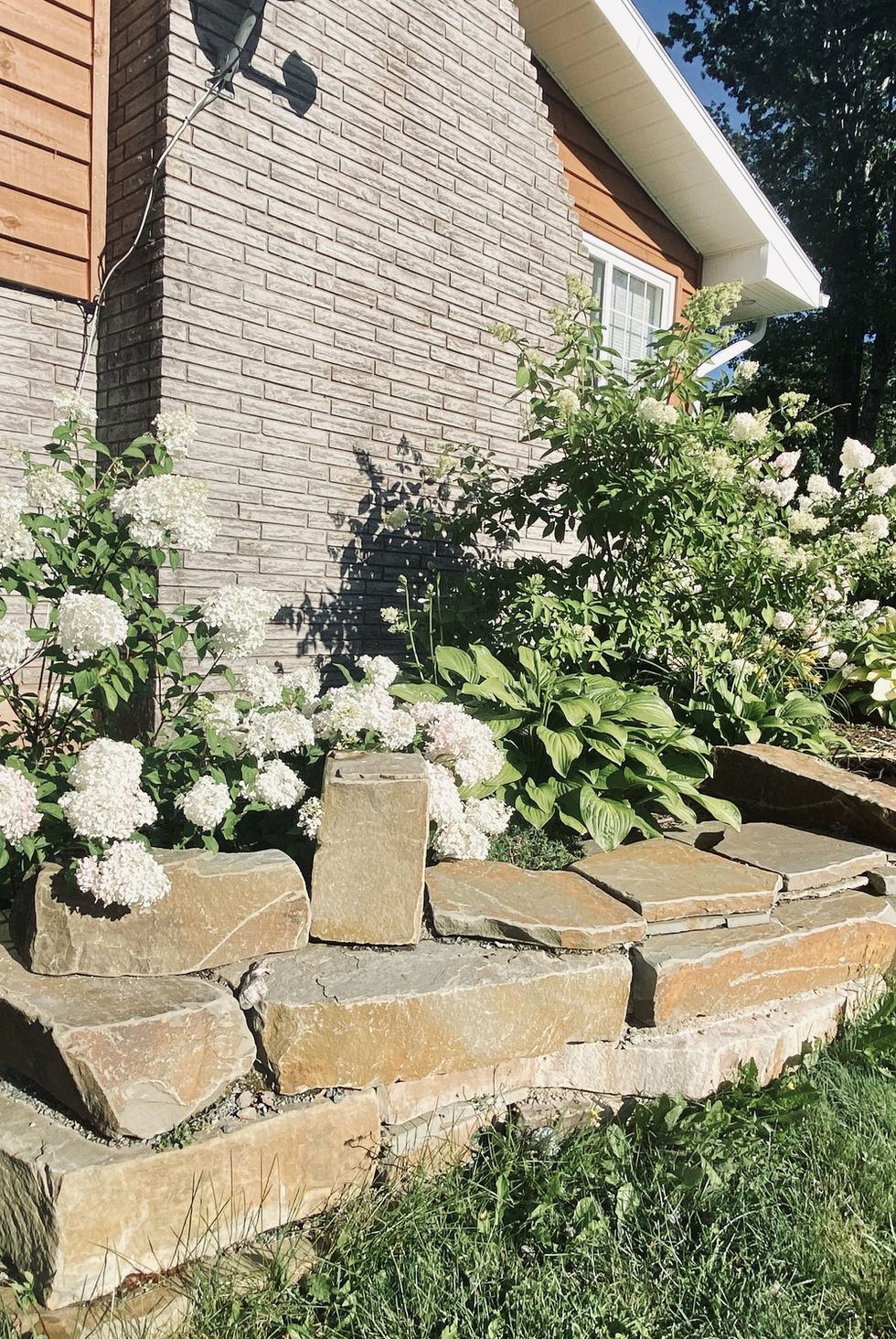 beautiful rock and flower garden alongside country home