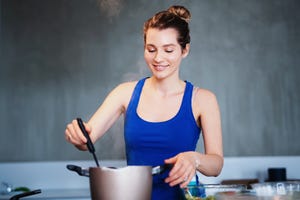 beautiful skinny girl cooks homemade food in the kitchen female chef