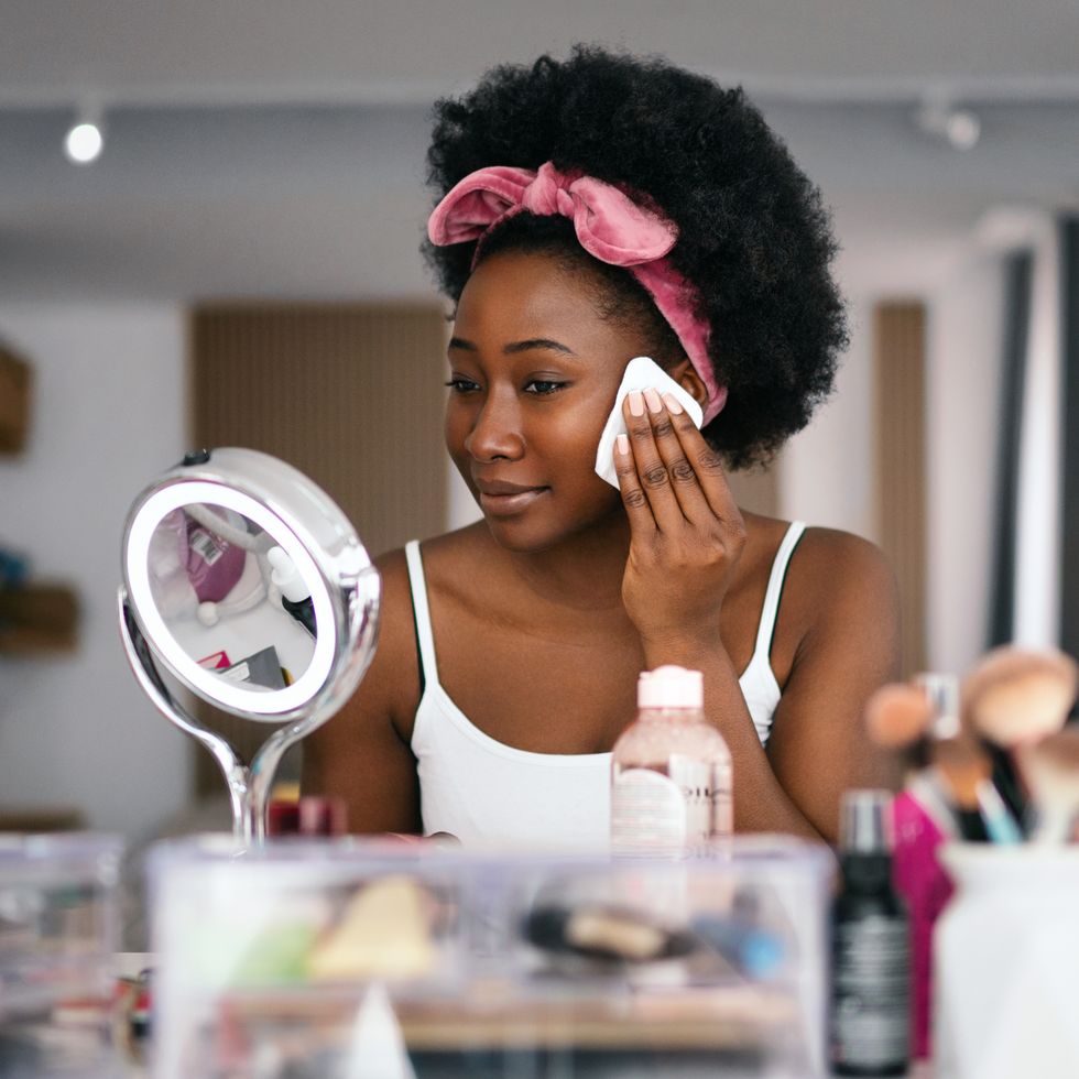 beautiful woman cleaning her face with a face cloth