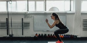 Beautiful woman doing box squats at the gym