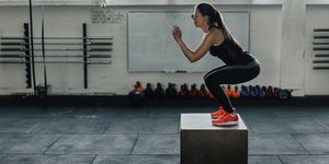 Beautiful woman doing box squats at the gym