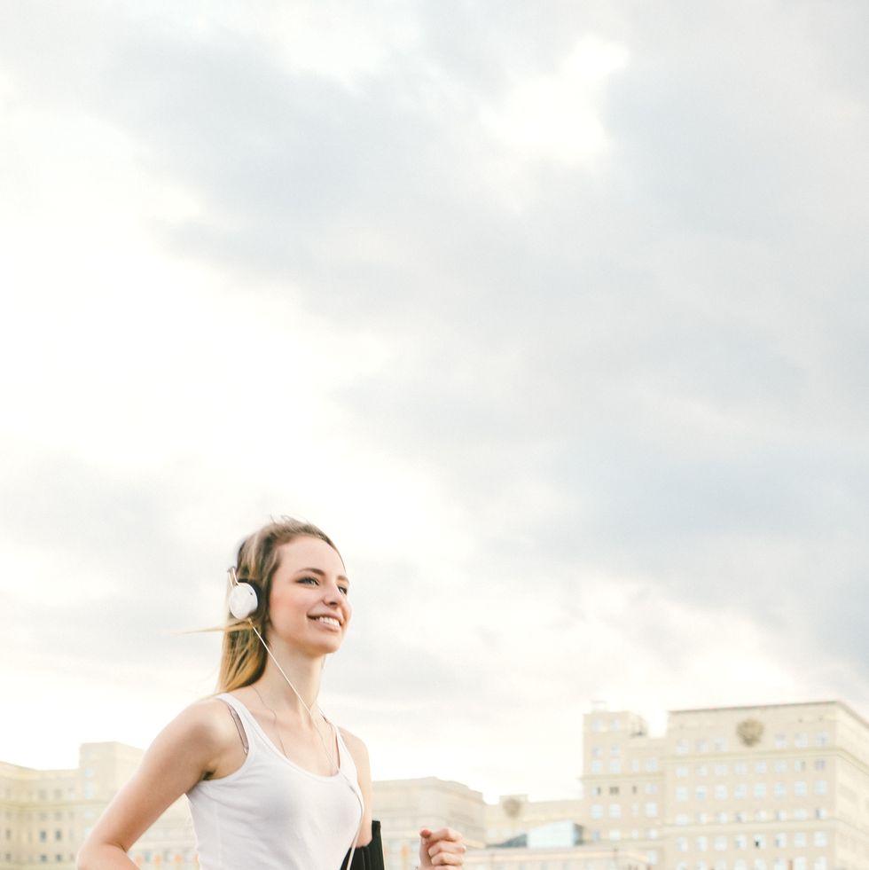 beautiful woman running and listening to her favorite music