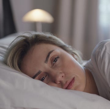 beautiful woman sleeping peacefully in her bed woman wakes up and stretches