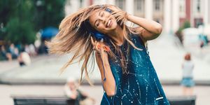 Beautiful woman tossing hair to the music